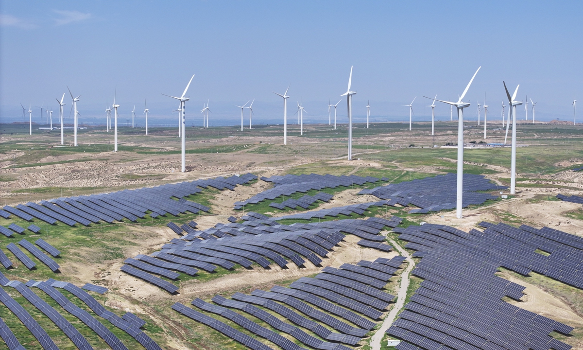 Photovoltaic panels and wind-power generation installations in Hongsibu District Photo: IC