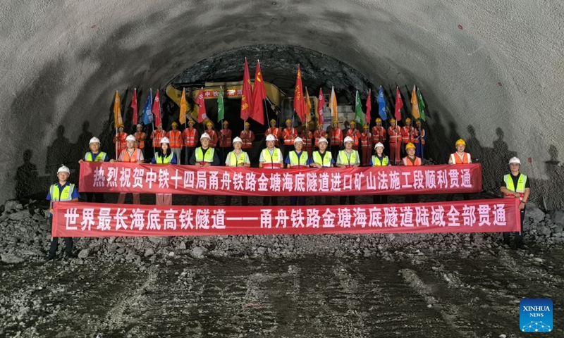 Construction workers pose for a group photo in celebration of the full breakthrough of the land section of the Jintang undersea tunnel, in east China's Zhejiang Province, Sept. 4, 2026. The 7.83-km land section of the 16.18-km Jintang undersea tunnel achieved full breakthrough on Friday. The tunnel is an important facility for the Yongzhou (Ningbo-Zhoushan) high-speed railway, and is designed as a single-bore, double-track tunnel for speeds of up to 250 km per hour. (Xinhua/Xu Yu)

