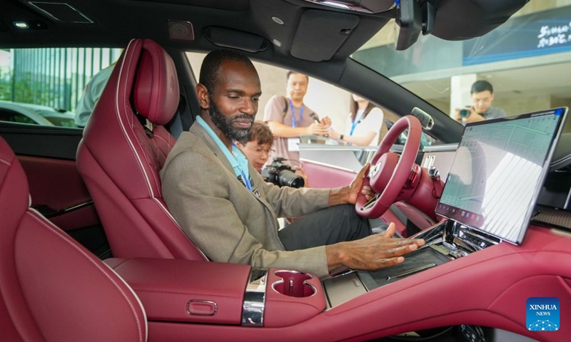 A guest learns about a BYD car in the exhibition hall at BYD's headquarters in Shenzhen, south China's Guangdong Province, Sept. 4, 2026.(Xinhua/Dai Mingxuan)

