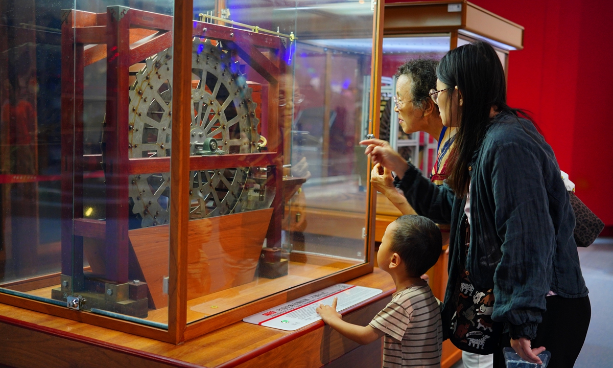 Visitors view a scale model of the escapement mechanism for a Northern Song Dynasty (960-1127) hydro?mechanical astronomical and time?keeping device at an exhibition at the China Science and Technology Museum in Beijing on September 6, 2026. Since 2025, September has been designated as China's annual National Science Popularization Month. Photo: VCG