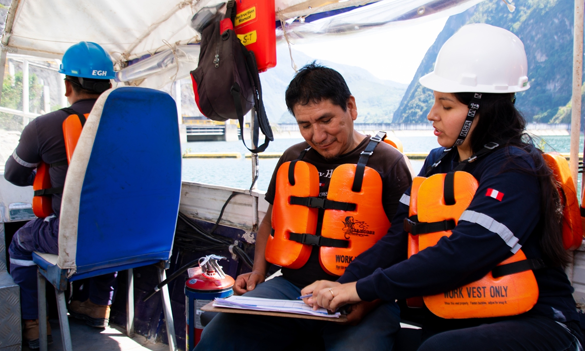 Passengers and staff wear life jackets aboard a boat providing free community transport on the Chaglla Reservoir in Peru's Huánuco region.