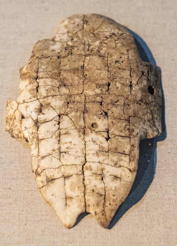 An oracle bone inscription from the Shang Dynasty  Children look at a fully restored Ming Dynasty 