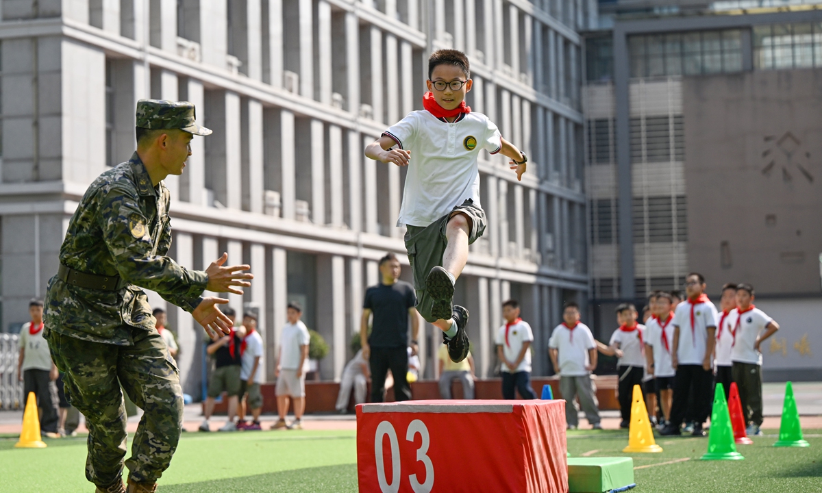A student jumps over an obstacle during a fun challenge event to mark the National Defense Education Month in Hefei, East China's Anhui Province, on September 8, 2026. Various activities are being held across the country to mark the National Defense Education Month in September. Photo: VCG