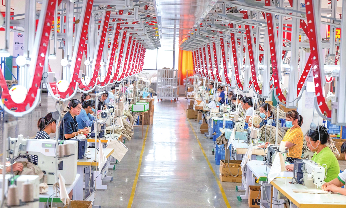 Workers at a factory in Dahua county, Hechi, South China's Guangxi Zhuang Autonomous Region, race to complete orders for protective uniforms on September 10, 2026. The factory, a demonstration project backed by China Datang Co to promote rural vitalization, mainly produces personal protective equipment such as anti-static clothing. Photo: VCG