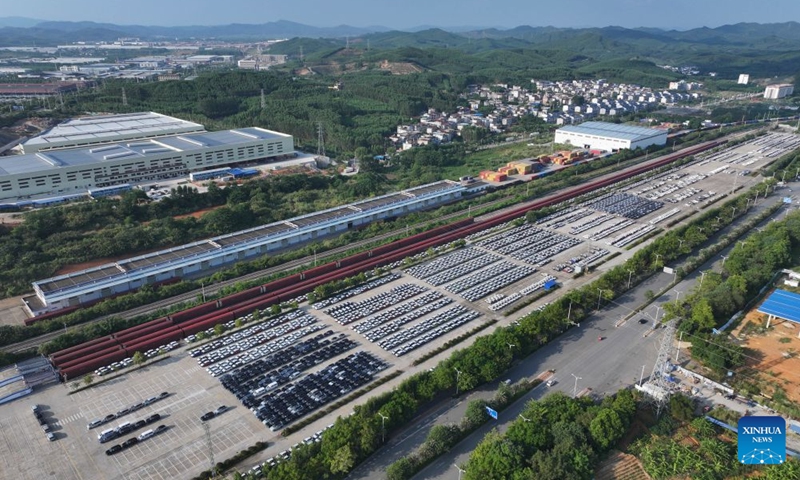 An aerial drone photo shows cars waiting to be exported via freight trains at an automobile logistics base in Liuzhou, south China's Guangxi Zhuang Autonomous Region, April 9, 2026.(Photo by Zheng Changhao/Xinhua)