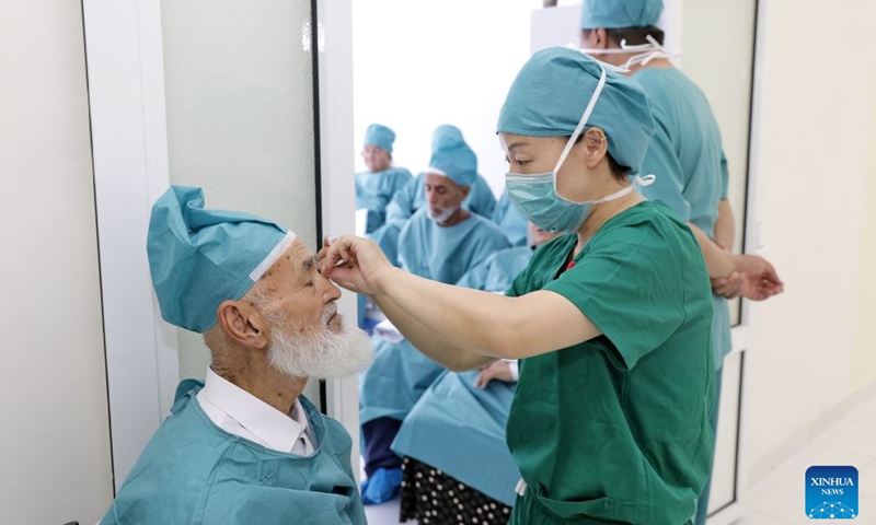 A member of a Chinese medical team prepares a patient for his eye surgery at the Samarkand Branch of the Republican Specialized Scientific and Practical Medical Center of Eye Microsurgery in Samarkand, Uzbekistan, Sept. 10, 2026. (Xinhua/Zafar Khalilov)