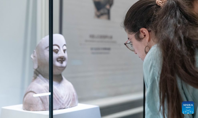 A visitor views an exhibit at an exhibition of cultural relics from China's Hebei province, in Belgrade, Serbia, Sept. 10, 2026. An exhibition featuring precious cultural relics from China's Hebei province opened Thursday at the National Museum of Serbia in Belgrade. Titled Smiles Fill the World: Hebei 'Smiles' on Chinese Cultural Relics, the exhibition centers on the theme of smiles and showcases 31 sets of cultural relics from Hebei, including pottery figurines, sculptures and porcelain. (Photo by Wang Wei/Xinhua)