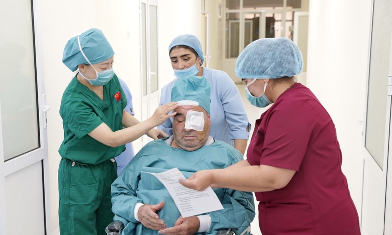 Medical staff from China and Uzbekistan take care of a patient after his cataract operation at the Samarkand Branch of the Republican Specialized Scientific and Practical Medical Center of Eye Microsurgery in Samarkand, Uzbekistan, Sept. 10, 2026. (Xinhua/Zafar Khalilov)