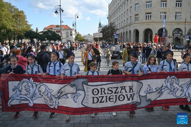 People take part in the sixth Procession of History, in Warsaw, Poland, Sept. 12, 2026. The event promotes history education through a historical procession, performances and interactive activities. (Photo by Aleksy Witwicki/Xinhua)