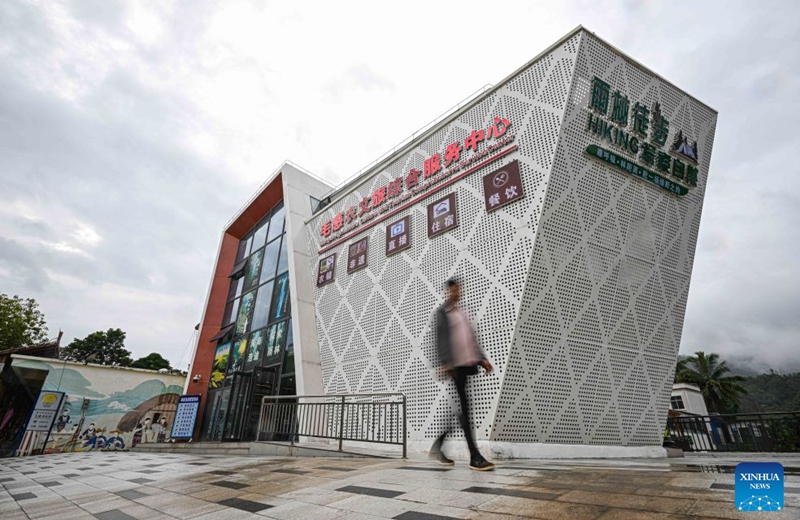 This photo taken on Sept. 11, 2026 shows the Maogan Agriculture, Culture and Tourism Comprehensive Service Center in Maogan Township of Baoting Li and Miao Autonomous County, south China's Hainan Province. The scenic ring road surrounding the Hainan Tropical Rainforest National Park passes through nine cities and counties in Hainan, including Lingshui, Baoting, Ledong and Changjiang, with a total length of 466 kilometers. The ring road was officially opened to traffic in December 2024.
This road connects the beautiful scenery of the mountainous areas in the central and southern parts of Hainan Island and builds a green corridor that balances ecological protection and cultural tourism development.
At present, many tourists come to cycle and drive on the road, boosting tourism-related consumption including accommodation, catering, specialty agricultural products, and outdoor culture and tourism along the road. Photo: Xinhua