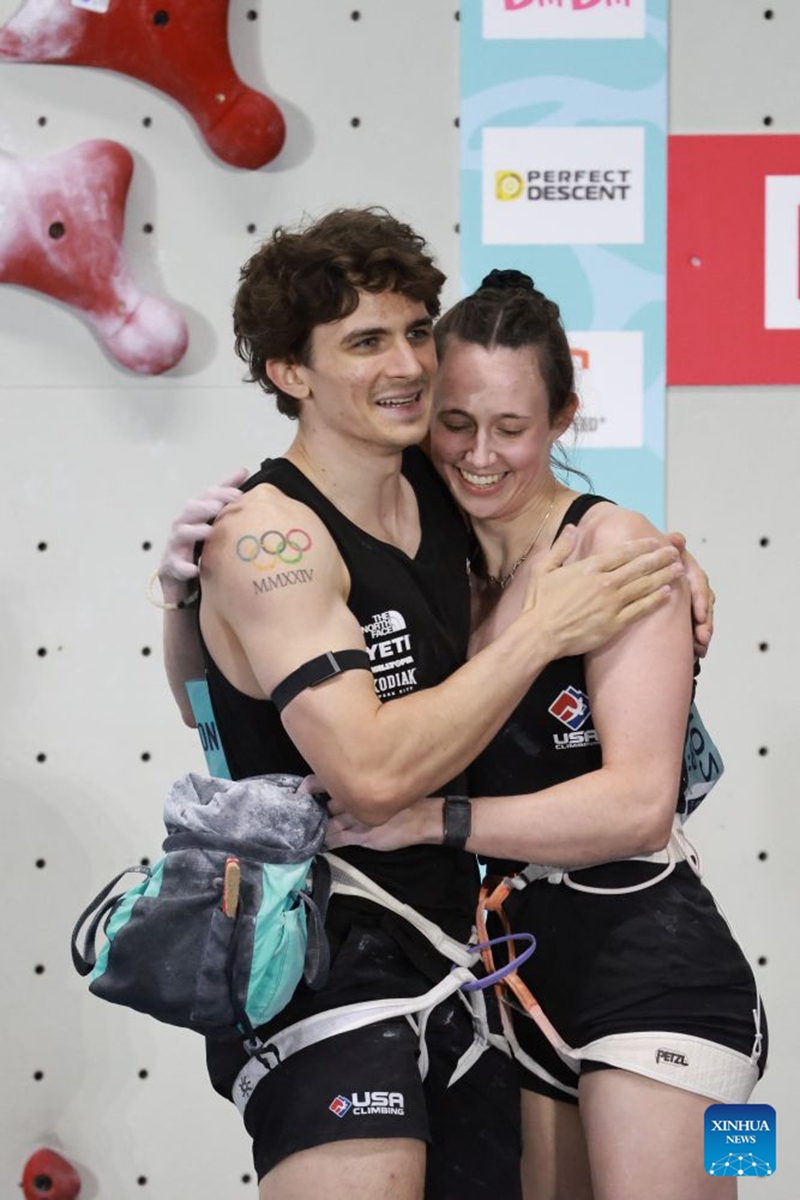 Samuel Watson (L) of the United States hugs his partner Emma Hunt after the mixed speed relay at the World Climbing Series Guiyang 2026 in Guiyang, southwest China's Guizhou Province, Sept. 12, 2026. (Xinhua/Liu Xu)