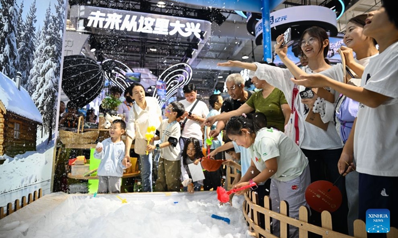 Visitors touch artificial snow at the themed exhibition area for culture and tourism services during the 2026 China International Fair for Trade in Services (CIFTIS) at Shougang Park in Beijing, capital of China, Sept. 12, 2026. The 2026 CIFTIS, running from Sept. 9 to 13 at Shougang Park in Beijing, has brought together 413 exhibitors at the themed exhibition area for culture and tourism services, showcasing emerging models of cultural and tourism integration. (Xinhua/Zheng Huansong)