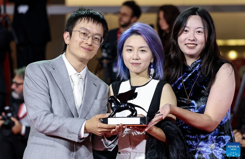 Main crew of the short film The Pigeon Ring pose with the trophy after the awarding ceremony of the 83rd Venice International Film Festival in Venice, Italy, Sept. 12, 2026. Chinese short film The Pigeon Ring won the Venice Immersive Grand Prize, the top award of the Venice Immersive section, at the 83rd Venice International Film Festival on Saturday. (Xinhua/Wang Kaiyan)