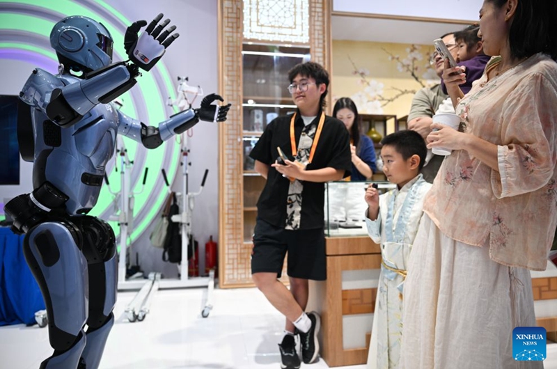 Visitors interact with a humanoid robot at the themed exhibition area for culture and tourism services during the 2026 China International Fair for Trade in Services (CIFTIS) at Shougang Park in Beijing, capital of China, Sept. 12, 2026. The 2026 CIFTIS, running from Sept. 9 to 13 at Shougang Park in Beijing, has brought together 413 exhibitors at the themed exhibition area for culture and tourism services, showcasing emerging models of cultural and tourism integration. (Xinhua/Zheng Huansong)
