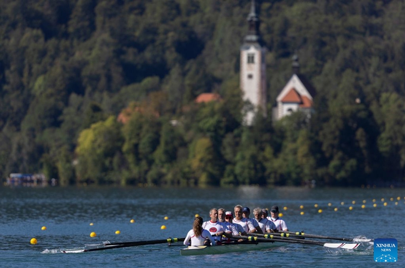 People participate in races on Lake Bled during the 2026 World Rowing Masters Regatta Bled in Bled, Slovenia, Sept. 12, 2026. (Photo by Zeljko Stevanic/Xinhua)