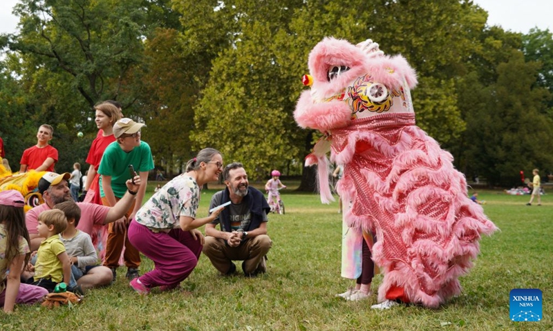 People interact with lion dancers during the 6th Family and Friends Gathering of the Hungarian Chan Wu Federation on Margaret Island in Budapest, Hungary, Sept. 13, 2026. (Xinhua/Chen Hao)

