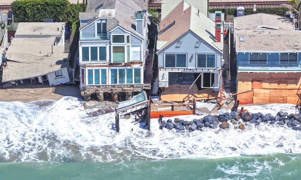 In an aerial view, a Pacific Ocean wave washes up near damaged beachfront homes on September 14, 2026, in Dana Point, California. Heavy surf from offshore Hurricane Marie left about 10 properties uninhabitable and prompted Dana Point to declare a local emergency over coastal erosion. Photo: VCG
