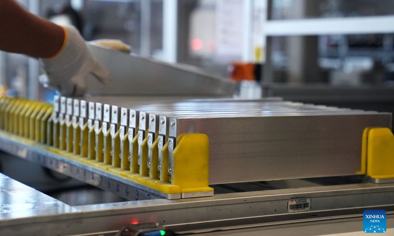 A worker arranges blade batteries at the BYD Fuzhou base in Fuzhou, east China's Jiangxi Province, Sept. 9, 2026. In the workshop of Chinese automaker BYD's Fuzhou base in Jiangxi, stamping, welding, painting and final assembly processes operate efficiently. Industrial robots and automated guided vehicles work in coordination, achieving full-process digital control. (Xinhua/Wan Xiang)

