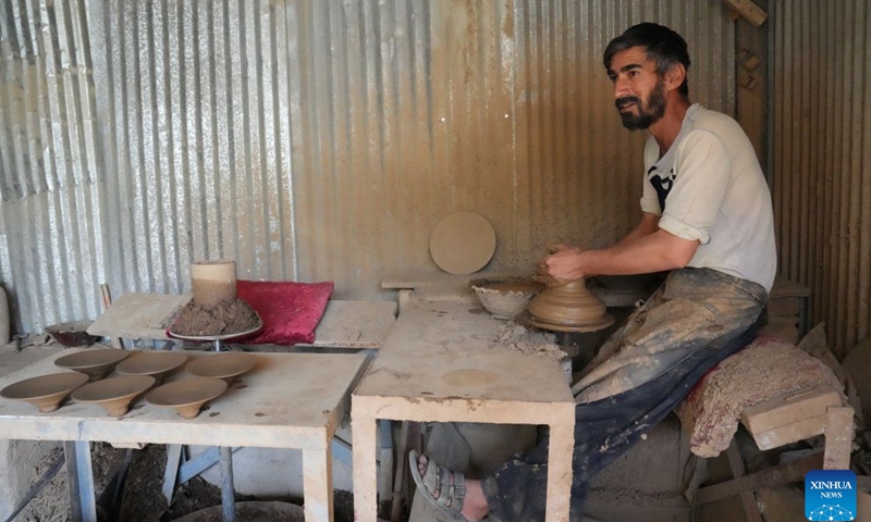 A craftsman shapes clay by hand in a workshop in Kabul, Afghanistan, Sept. 13, 2026. (Photo by Saifurahman Safi/Xinhua)

