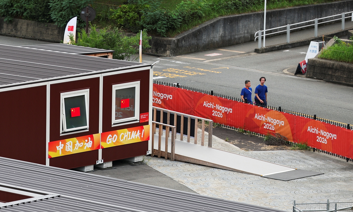 People walk past container units built to house Asian Games athletes, including those for Chinese athletes, ahead of the Aichi-Nagoya 2026 Asian Games in Nagoya, Japan, September 15, 2026.