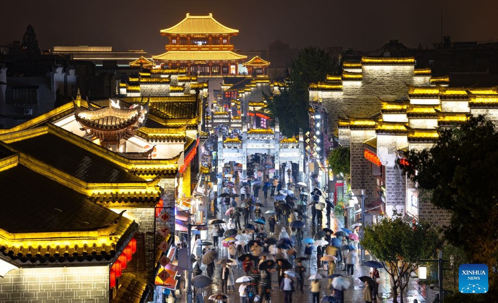 People visit Xiangyang ancient town at night in Xiangyang, central China's Hubei Province, Sept. 16, 2026. In recent years, Xiangyang in central China's Hubei Province has been promoting tourism through light shows, evening cruises, live performances and night markets. The city has also integrated its historical and cultural heritage into tourism, offering visitors a richer experience that blends local history with vibrant street life. (Xinhua/Xiao Yijiu)