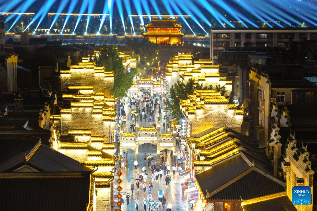 People visit Xiangyang ancient town at night in Xiangyang, central China's Hubei Province, Sept. 16, 2026. In recent years, Xiangyang in central China's Hubei Province has been promoting tourism through light shows, evening cruises, live performances and night markets. The city has also integrated its historical and cultural heritage into tourism, offering visitors a richer experience that blends local history with vibrant street life. (Xinhua/Xiao Yijiu)