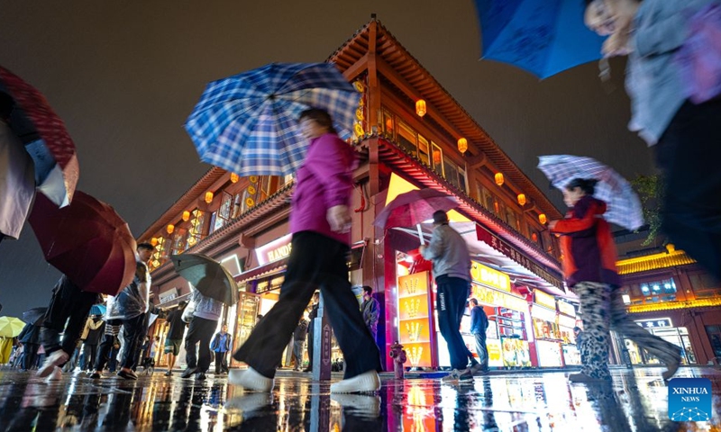 People visit Xiangyang ancient town at night in Xiangyang, central China's Hubei Province, Sept. 16, 2026. In recent years, Xiangyang in central China's Hubei Province has been promoting tourism through light shows, evening cruises, live performances and night markets. The city has also integrated its historical and cultural heritage into tourism, offering visitors a richer experience that blends local history with vibrant street life. (Xinhua/Xiao Yijiu)