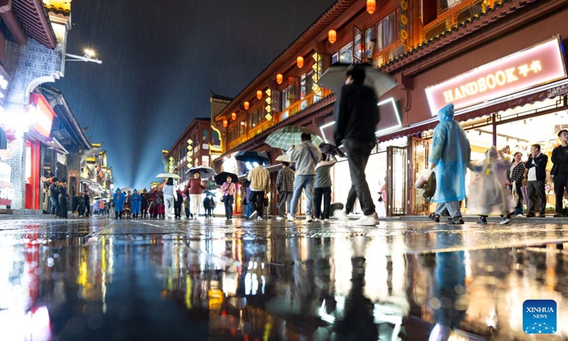 People visit Xiangyang ancient town at night in Xiangyang, central China's Hubei Province, Sept. 16, 2026. In recent years, Xiangyang in central China's Hubei Province has been promoting tourism through light shows, evening cruises, live performances and night markets. The city has also integrated its historical and cultural heritage into tourism, offering visitors a richer experience that blends local history with vibrant street life. (Xinhua/Xiao Yijiu)