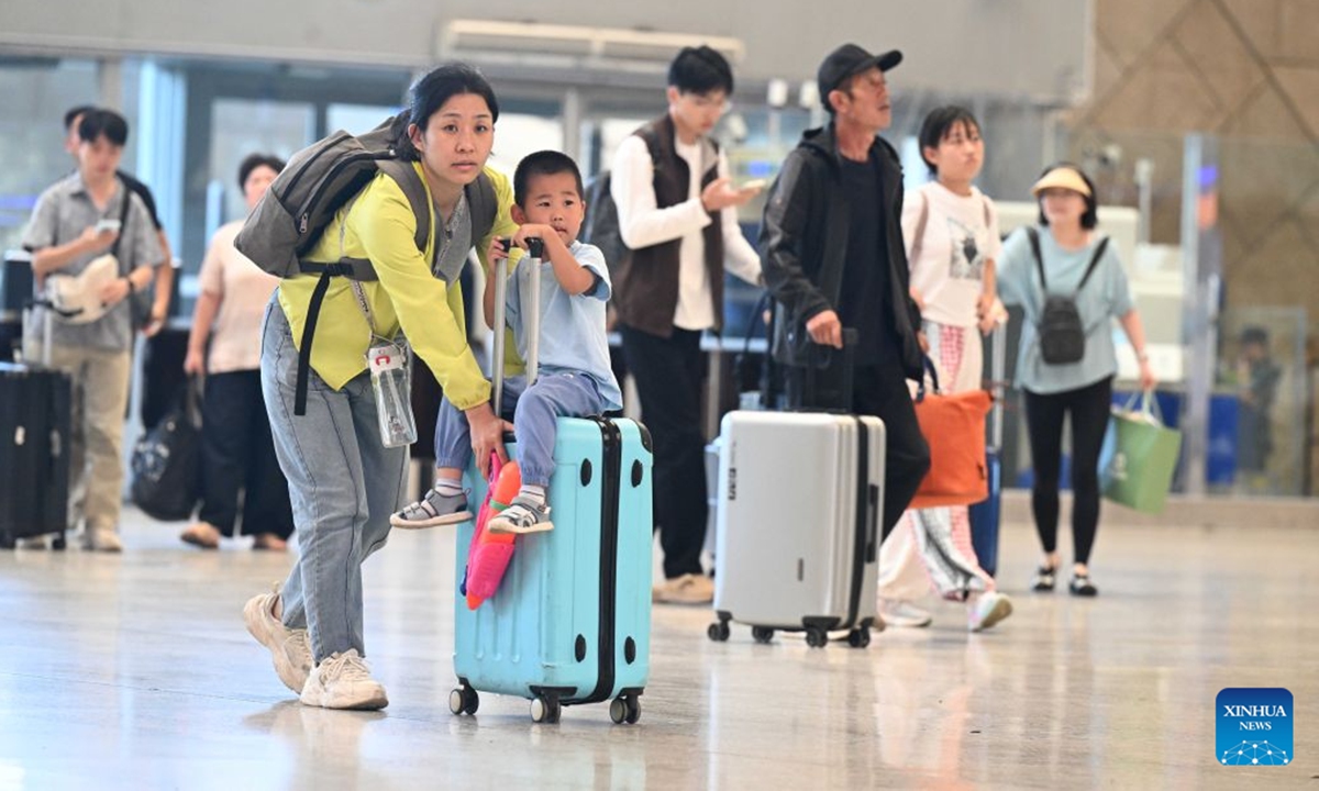 Passengers wait to check in at the waiting room of Shijiazhuang Railway Station in Shijiazhuang, north China's Hebei Province, Aug. 31, 2026. The 62-day summer travel rush officially concluded on Monday. (Photo by Chen Qibao/Xinhua)