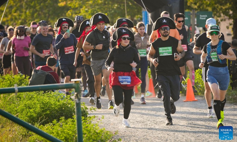 Runners dressed in pirate-themed costumes take part in the 2026 Big Pirate Run in Richmond, British Columbia, Canada, Sept. 19, 2026. Runners dressed as pirates took part in the themed event, which featured multiple race distances along trails here on Saturday. (Photo by Liang Sen/Xinhua)