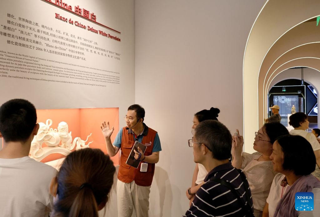 A staff member introduces a porcelain artwork to visitors at the WorldSkills Museum in east China's Shanghai, Sept. 19, 2026. With the 48th WorldSkills Competition approaching, the WorldSkills Museum is drawing growing attention. Visitors can learn about the history of the competition and traditional Chinese craftsmanship, and play interactive games based on competition events. (Xinhua/Fang Zhe)