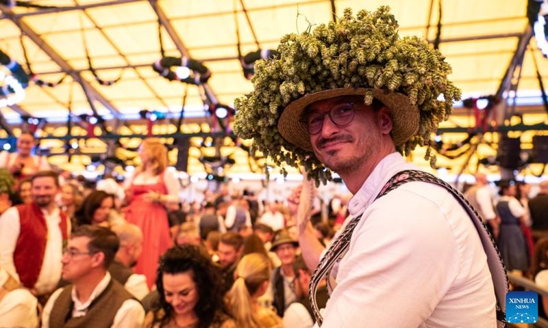 A man wearing a hat decorated with hops is pictured at the Oktoberfest in Munich, Germany, Sept. 19, 2026. The 191st Oktoberfest, one of the largest folk festivals in Germany, opened on Saturday in Munich, with mayor Dominik Krause tapping the first barrel of beer as a tradition. This year's festival will last until Oct. 4. Photo: Xinhua