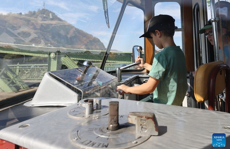 A child visits the interior of a tram during a car-free weekend event in Budapest, Hungary, on Sept. 19, 2026. Budapest is holding a car-free weekend on Sept. 19-20 as part of European Mobility Week, promoting environmentally friendly and sustainable travel through public transport vehicle displays, cycling activities and family events. (Photo by Attila Volgyi/Xinhua)