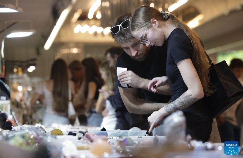 Visitors look at mineral specimen during the Mineral Fest in Ljubljana, Slovenia, Sept. 19, 2026. (Photo by Zeljko Stevanic/Xinhua)