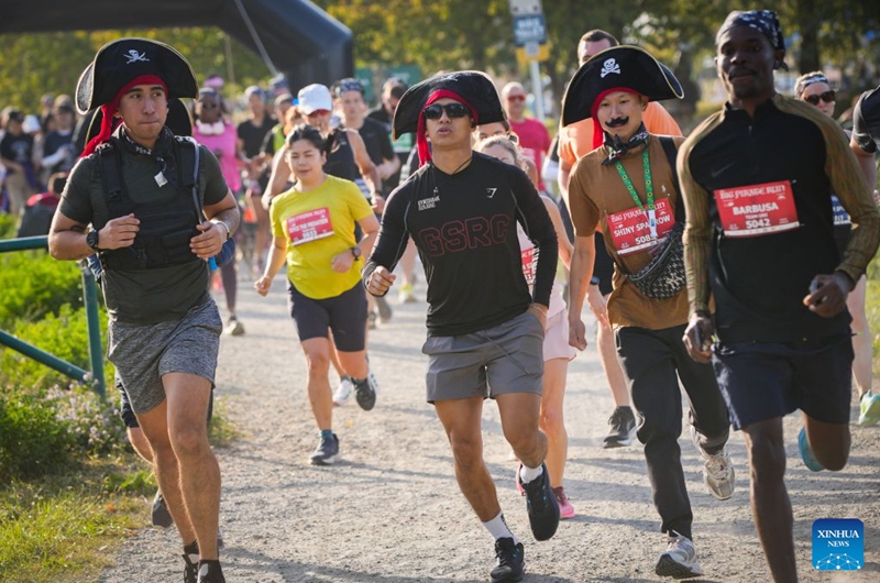 Runners dressed in pirate-themed costumes take part in the 2026 Big Pirate Run in Richmond, British Columbia, Canada, Sept. 19, 2026. Runners dressed as pirates took part in the themed event, which featured multiple race distances along trails here on Saturday. (Photo by Liang Sen/Xinhua)