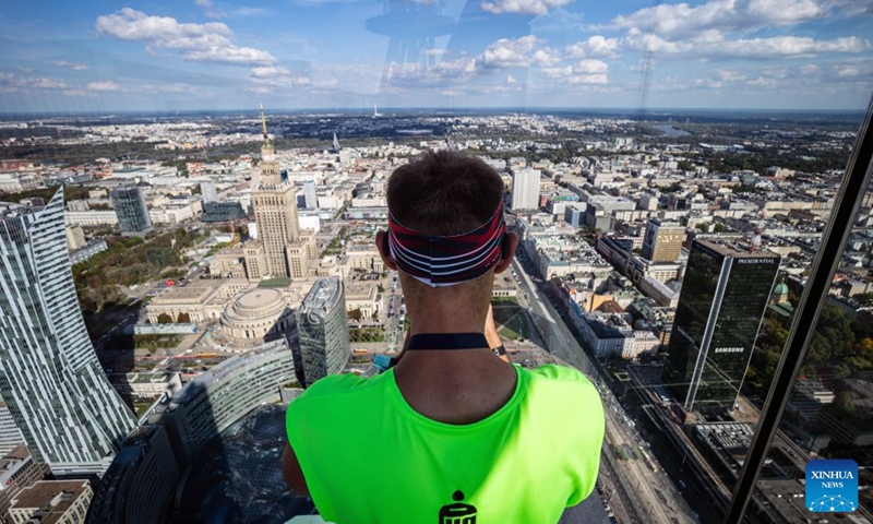 A man takes photos during the fifth edition of the Run Up Varso Tower stair-climbing race in Warsaw, Poland, Sept. 19, 2026. The event was held at Varso Tower in Warsaw on Saturday, with runners climbing almost 1,400 stairs on their way to the finish line located on the Highline Warsaw observation deck. (Photo by Jaap Arriens/Xinhua)