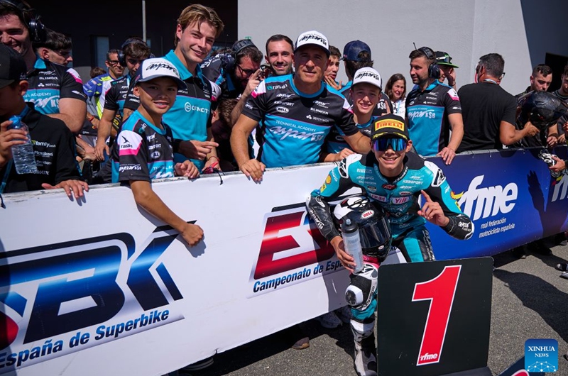 CFMOTO Aspar's rider Sun Shengbo (front R) of China poses with team members after winning the race 1 of the ESBK Talent category at the 2026 Spanish Superbike Championship Navarra in Navarra, Spain, Sept. 19, 2026. Photo: Xinhua