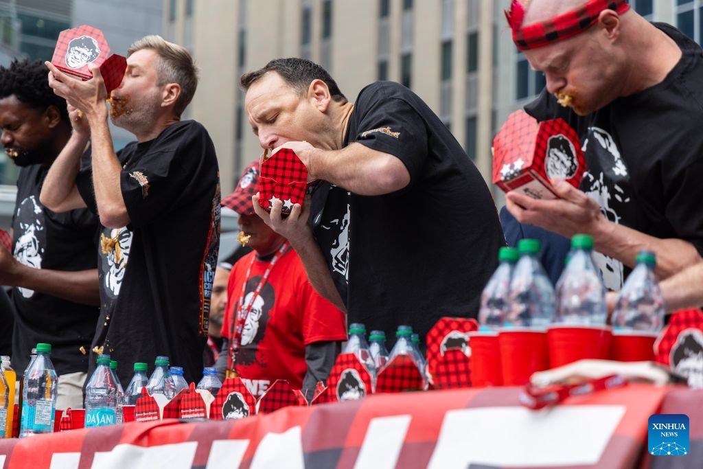 Contestants compete during the 2026 World Poutine Eating Championship in Toronto, Canada, on Sept. 19, 2026. The annual event took place in Toronto on Saturday, with 13 competitive eaters. Joey Chestnut of the United States claimed the title after eating 21.25 pounds of poutine in 10 minutes. (Photo by Zou Zheng/Xinhua)