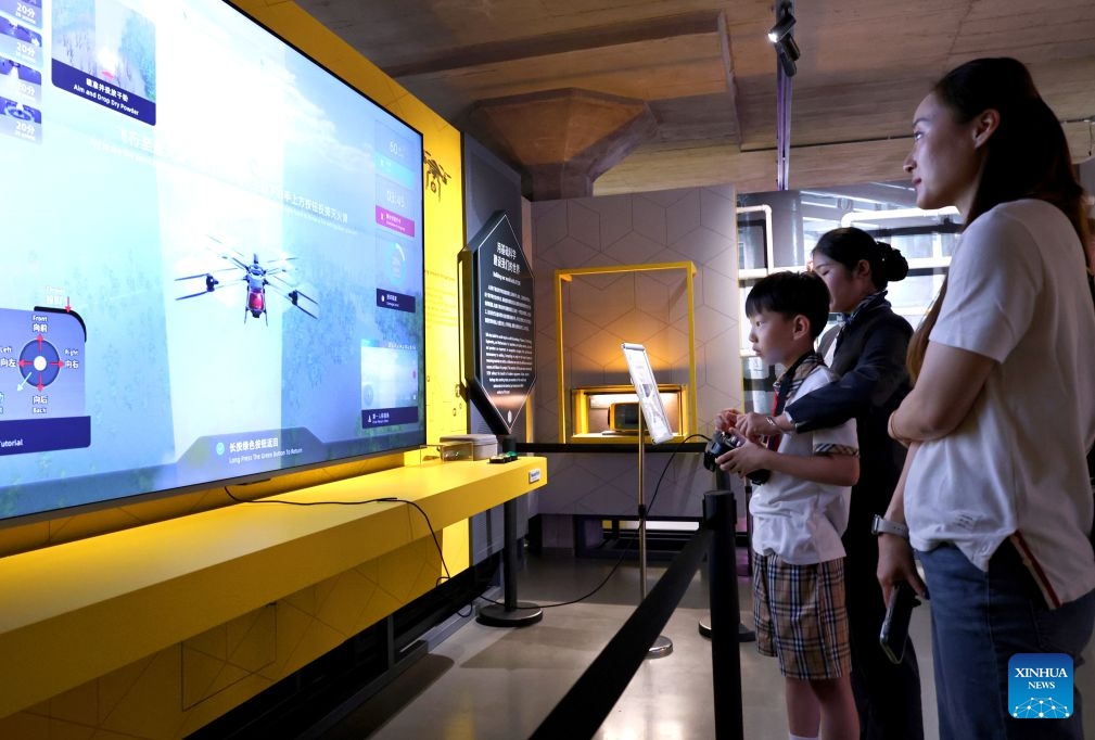 Visitors play a drone flight simulation game at the WorldSkills Museum in east China's Shanghai, Sept. 19, 2026. With the 48th WorldSkills Competition approaching, the WorldSkills Museum is drawing growing attention. Visitors can learn about the history of the competition and traditional Chinese craftsmanship, and play interactive games based on competition events. (Xinhua/Fang Zhe)