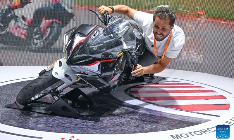 A foreign visitor tries out a motorcycle at the 24th China International Motorcycle Trade Exhibition in Chongqing, southwest China, Sept. 19, 2026. The 24th China International Motorcycle Trade Exhibition is held in Chongqing from Sept. 19 to 22. (Xinhua/Chen Cheng)