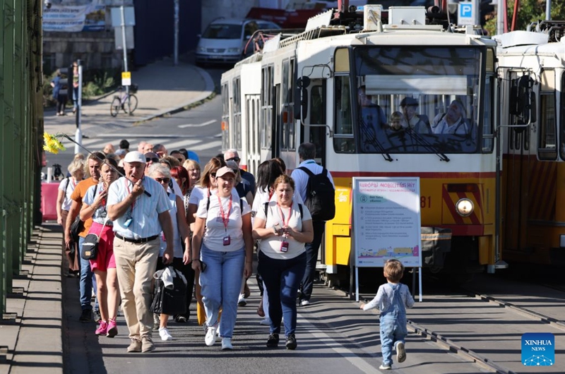 People attend a car-free weekend event in Budapest, Hungary, on Sept. 19, 2026. Budapest is holding a car-free weekend on Sept. 19-20 as part of European Mobility Week, promoting environmentally friendly and sustainable travel through public transport vehicle displays, cycling activities and family events. (Photo by Attila Volgyi/Xinhua)