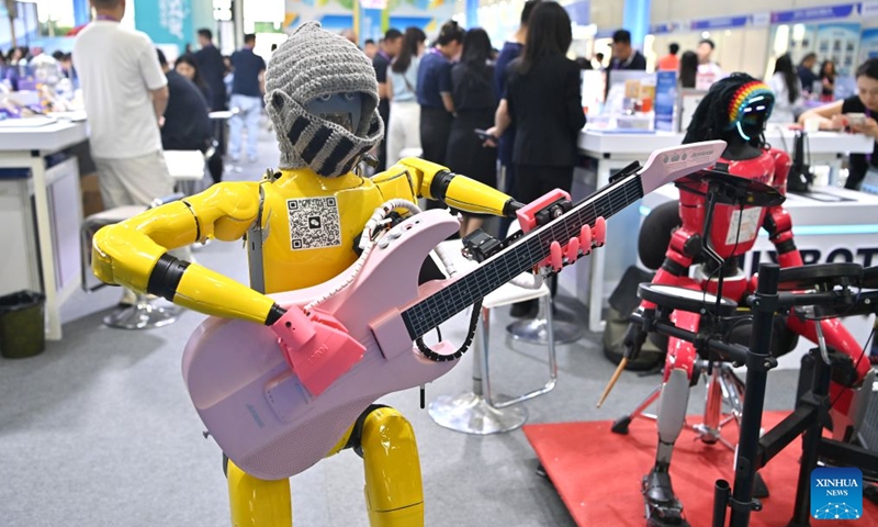 A humanoid robot plays the guitar at the 23rd China-ASEAN Expo in Nanning, south China's Guangxi Zhuang Autonomous Region, Sept. 19, 2026. Multiple intelligent robots were showcased and demonstrated a variety of skills at the China-ASEAN Expo. (Xinhua/Zhou Hua)
