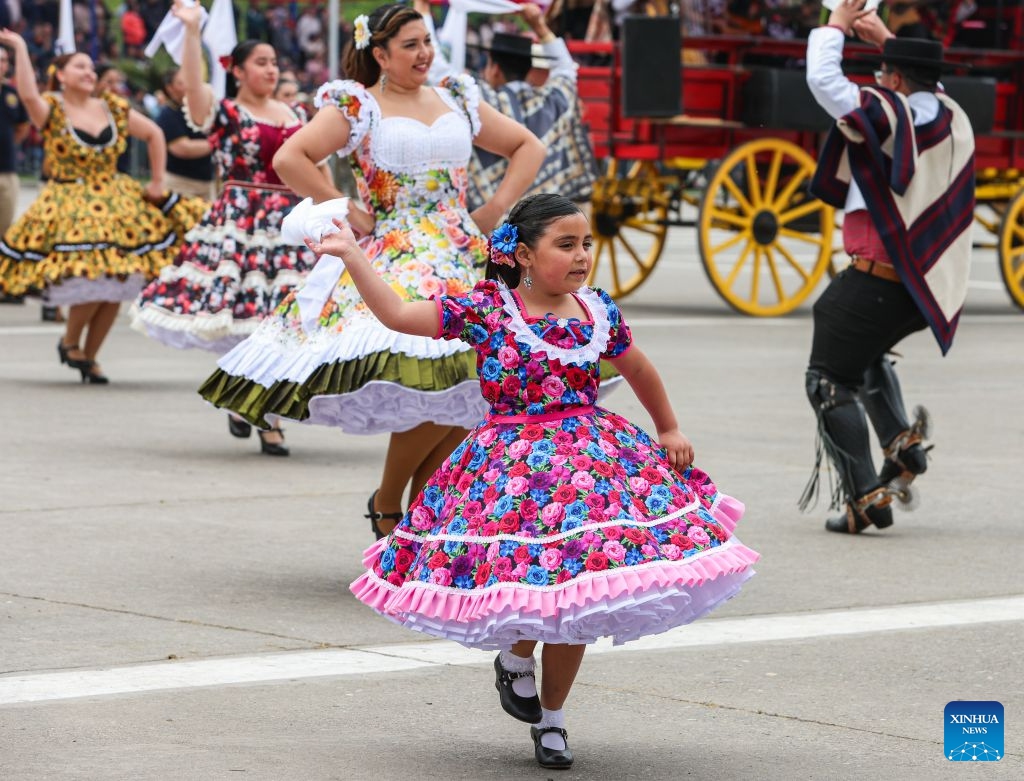 Performers in traditional attire dance before the annual military parade to celebrate the Day of the Glories of the Army at the O'Higgins park, in Santiago, Chile, Sept. 19, 2026. (Xinhua/Zhou Jiayi)