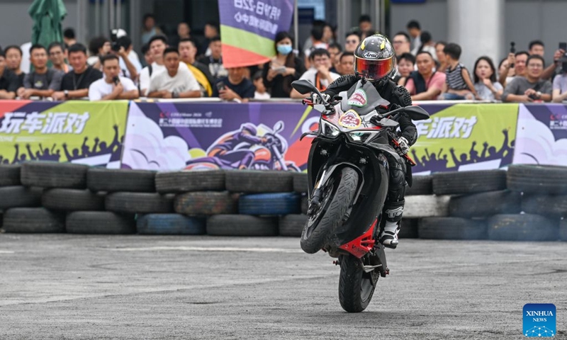 A motorcycle stunt show is staged at the 24th China International Motorcycle Trade Exhibition in Chongqing, southwest China, Sept. 19, 2026. The 24th China International Motorcycle Trade Exhibition is held in Chongqing from Sept. 19 to 22. (Xinhua/Chen Cheng)