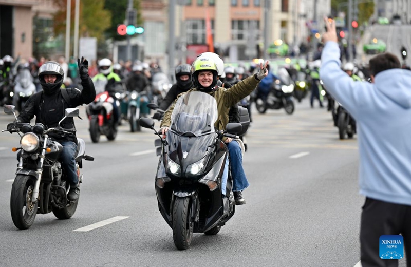 Motorcyclists interact with audience during a parade in Moscow, Russia, on Sept. 19, 2026. The parade marked the end of this year's motorcycle season in Moscow. (Photo by Alexander Zemlianichenko Jr/Xinhua)