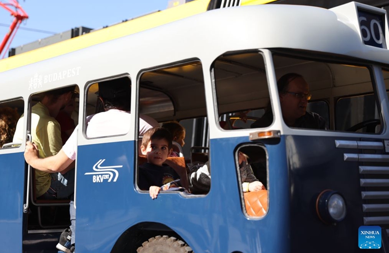 People take a mini bus during a car-free weekend event in Budapest, Hungary, on Sept. 19, 2026. Budapest is holding a car-free weekend on Sept. 19-20 as part of European Mobility Week, promoting environmentally friendly and sustainable travel through public transport vehicle displays, cycling activities and family events. (Xinhua/Hu Zhixuan)