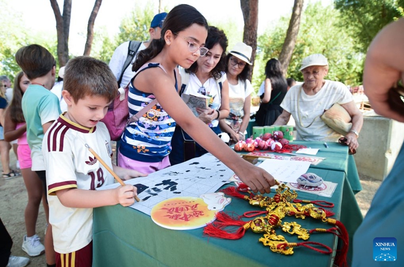 Visitors enjoy activities during the celebration of the 6th birthday of the giant panda couple Jin Xi and Zhu Yu, at Madrid Zoo in Madrid, Spain, on Sept. 19, 2026. The sixth birthday party of the giant panda couple Jin Xi and Zhu Yu was held here on Saturday. (Photo by Gustavo Valiente/Xinhua)