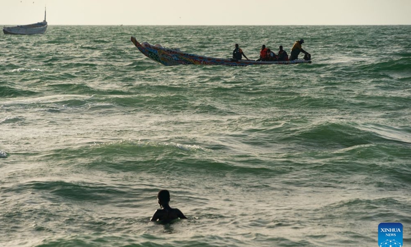 People enjoy leisure time at the Nouakchott Fishing Port in Nouakchott, Mauritania, Sept. 20, 2026. The Nouakchott Fishing Port, located on the Atlantic coast, is an important fishing hub in Mauritania. The port is known for its rows of traditional wooden pirogues and is a popular gathering place for local residents. (Xinhua/Xie Jianfei)