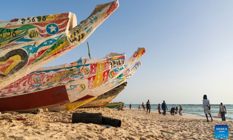 Traditional wooden pirogues are seen at the Nouakchott Fishing Port in Nouakchott, Mauritania, Sept. 20, 2026. The Nouakchott Fishing Port, located on the Atlantic coast, is an important fishing hub in Mauritania. The port is known for its rows of traditional wooden pirogues and is a popular gathering place for local residents. (Xinhua/Xie Jianfei)