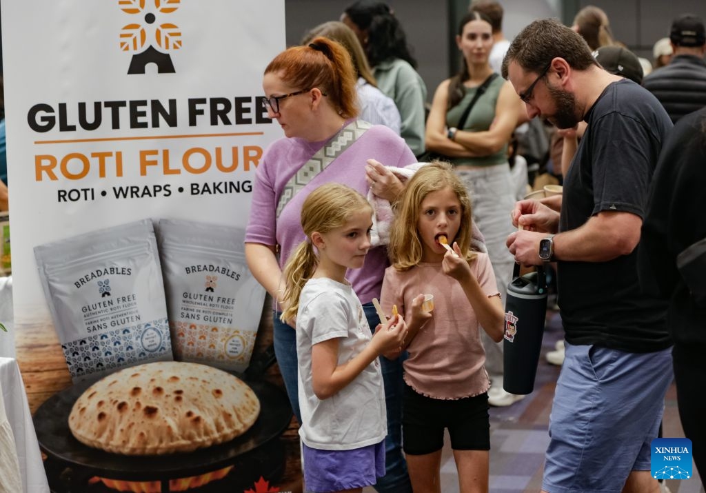 Visitors taste gluten free food products at the Gluten Free Expo in Vancouver, British Columbia, Canada, Sept. 20, 2026. The event featured gluten-free food and beverage products, sampling, shopping and educational presentations. (Photo by Liang Sen/Xinhua)